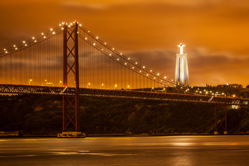 suspension bridge over Tagus river and big Christ monument in Lisbon, Portugal